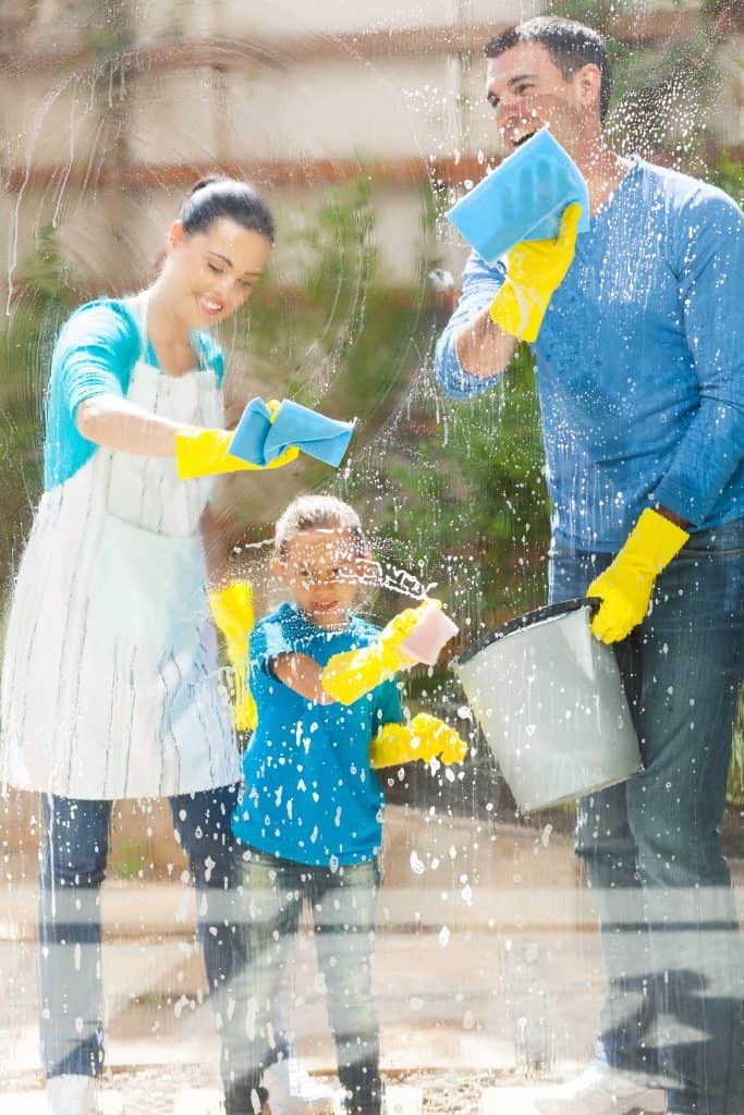 happy family cleaning home window